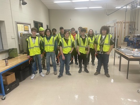 Electrician class showing off their new tools and tool belts.
